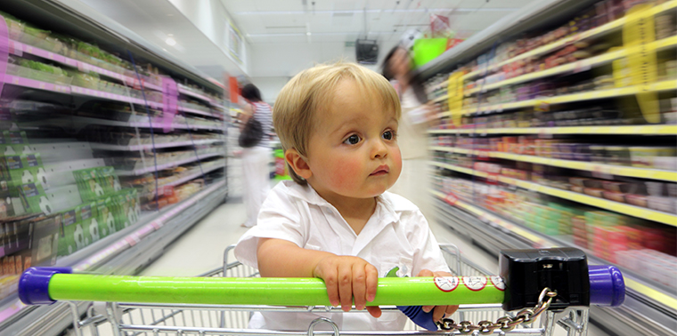 Child in shopping cart with blurred background