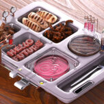 Futuristic cafeteria tray with meat printer, crickets, chicken-free strips, mealworms and test tube burger
