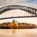 Cargo ship passing under bridge