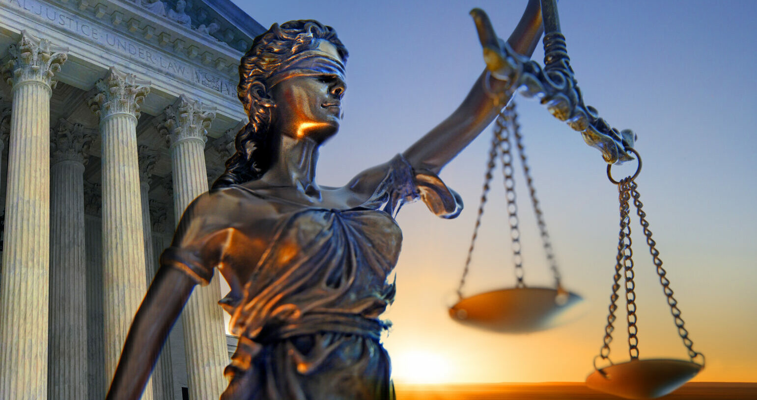 A statue of the blindfolded lady justice in front of the United States Supreme Court building as the sun rises in the distance symbolizing the dawning of a new era.