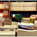 Photo of publications from Muséum national d’Histoire naturelle on table and bookshelf