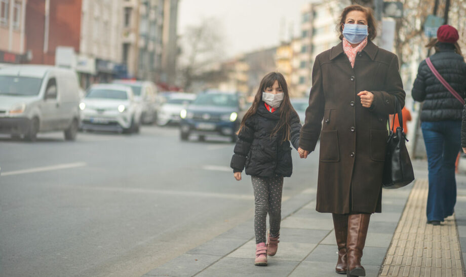 woman are going to work.she wears N95 mask.prevent PM2.5 dust and smog, mother and child wearing a mask to protect their child from air pollution and infectious diseases