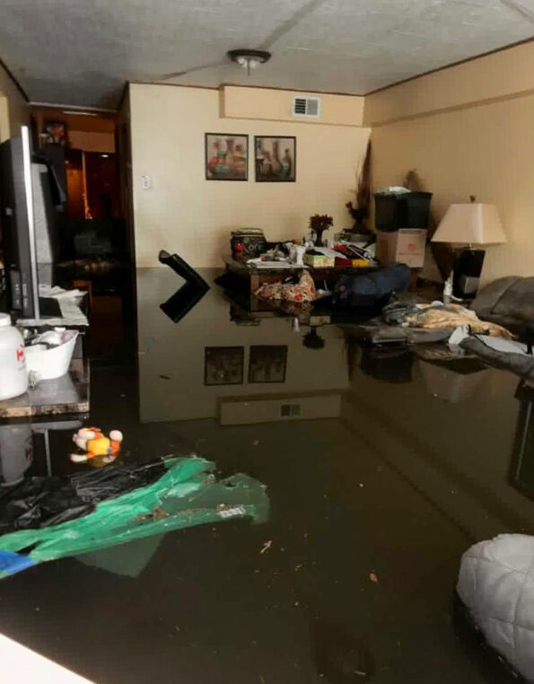 The basement apartment that Marisol Nuñez shares with her mother and their dog, Princess, was flooded with about three and a half feet of water during the storm in Cicero, Ill. Image shows flooded basement with furniture and other household items floating.
