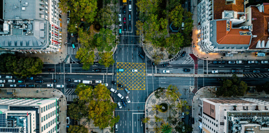 Top Down Aerial View of Cars Driving Intersection at Lisbon