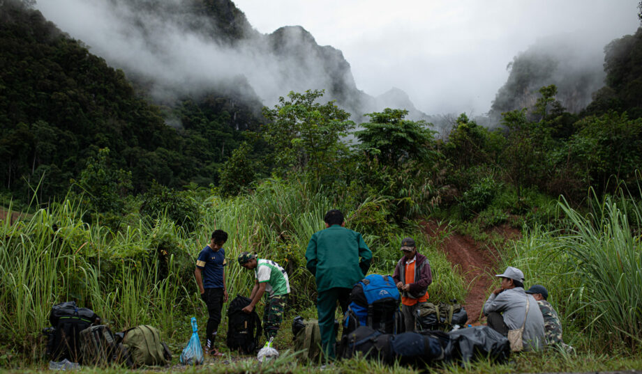 The Saola Foundation team is seen in the foreground getting ready to search for the saola in the Annamite Mountains, which can be seen in the background