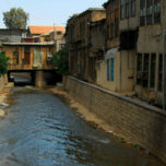 Damascus, Syria: Barada river, seen from Al Thawra street - the city's main river flows within artificial banks and shabby houses - photo by M.Torres