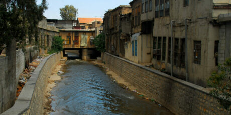 Damascus, Syria: Barada river, seen from Al Thawra street - the city's main river flows within artificial banks and shabby houses - photo by M.Torres