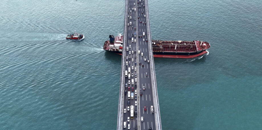 From Above,the Bosphorus Bridge in Istanbul Spans the Shimmering Waters of the Marmara Sea. Vehicles Traverse the Bridge While a Barge Glides Beneath,Capturing the Dynamic Movement of the City against the Tranquil Seascape Backdrop